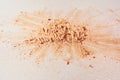 Scattered face powder on a white background, top view. With space to copy. Scattered crumbs of powder or eye shadow Royalty Free Stock Photo