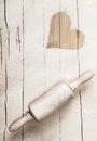 Scattered flour on an old wooden rolling pin Royalty Free Stock Photo