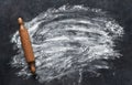 Scattered flour and rolling pin on the stone kitchen table. View from above. Cooking baking Royalty Free Stock Photo