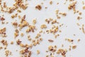Scattered granola on textured white surface. Food backgrounds.