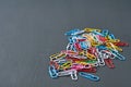 Scattered heap different colors paper clips red, green, blue, yellow, white and pink for office work or education Royalty Free Stock Photo