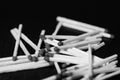 Scattered matches on dark background. Black and white Royalty Free Stock Photo