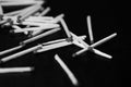 Scattered matches on dark background. Black and white Royalty Free Stock Photo