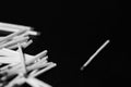 Scattered matches on dark background. Black and white Royalty Free Stock Photo