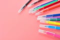 Scattered multi colored felt pens lies on pink desk in kindergarten