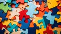 Scattered multi coloured jig saw puzzle pieces top view