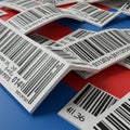 Scattered over a red and blue surface are numerous white papers, each featuring