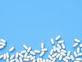 Scattered parmaceutical medicine pill tablets on the blue background. Mock up template. Health care concept. 3d render