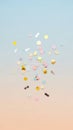 Scattered pastel and metallic confetti including circles rectangles and dots on a soft gradient background of blue and peach hues Royalty Free Stock Photo