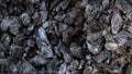 Scattered pieces of embers in hearth mixed with ash. Black charcoal briquettes Royalty Free Stock Photo