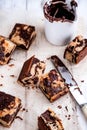 Scattered pieces of marble cake with chocolate on cooking paper, top view Royalty Free Stock Photo