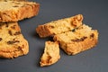 Scattered pieces of tasty sweet homemade bread with raisin lies on dark concrete table in kitchen Royalty Free Stock Photo