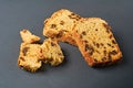 Scattered pieces of tasty sweet homemade bread with raisin lies on dark concrete table in kitchen Royalty Free Stock Photo