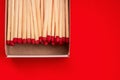 Scattered on a pile of wooden matches with matches on a red background Royalty Free Stock Photo