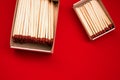 Scattered on a pile of wooden matches with matches on a red background Royalty Free Stock Photo