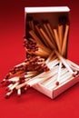 Scattered on a pile of wooden matches with matches on a red background Royalty Free Stock Photo