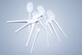 Scattered plastic forks knives spoons on a gray background close-up Royalty Free Stock Photo