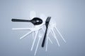 Scattered plastic forks knives spoons on a gray background close-up Royalty Free Stock Photo