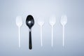 Scattered plastic forks knives spoons on a gray background close-up Royalty Free Stock Photo