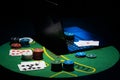 Scattered poker chips and cards on a green table with and laptop Royalty Free Stock Photo