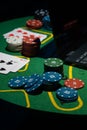 Scattered poker chips and cards on a green table with and laptop Royalty Free Stock Photo