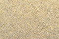 Scattered and polished groats of millet texture. Grains pattern, food background, texture idea.