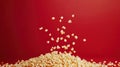 Pile of Popcorn Against a Red Background With Kernels Floating Royalty Free Stock Photo