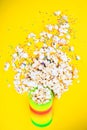 Scattered popcorn on a yellow background. Abstraction and minimalism.