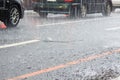 Scattered raindrops and cars on road