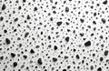 Scattered smooth black and grey pebbles and rough granular elements create a textured monochrome pattern. The background is Royalty Free Stock Photo