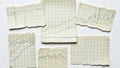 Scattered torn graph paper sheets with hand drawn lines and data Royalty Free Stock Photo