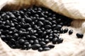 Scattered uncooked black turtle beans on kitchen cloth Royalty Free Stock Photo