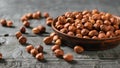 Scattered on a wooden table and in a clay bowl hazelnuts. Vegetarian cuisine Royalty Free Stock Photo