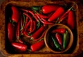A scattering bunch of red chilies and green Romano peppers on a wooden tray. Colorful juicy hot peppers. Shot from above Royalty Free Stock Photo