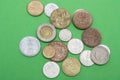 A scattering of coins on a green background Royalty Free Stock Photo