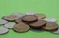 A scattering of coins on a green background Royalty Free Stock Photo