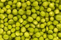 A scattering of fresh green peas from above, background