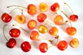 Scattering of fresh sweet ripe cherries with golden cherry on the table isolated on a white background.