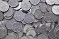A scattering of many Japanese coins in 1 yen. Gray or blue background or wallpaper. News about the economy, finances and interest Royalty Free Stock Photo
