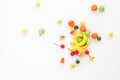 A scattering of many small different fruits on a white background. Mini copy, the concept of diversity of flavors and