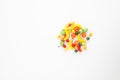 A scattering of many small different fruits on a white background. Mini copy, the concept of diversity of flavors and