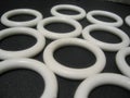Scattering of objects on black, white plastic rings Royalty Free Stock Photo