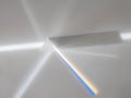 Scattering of a ray of sunlight white light through a prism creating refraction