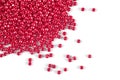 A scattering of red beads on a white isolated background