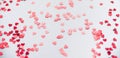 A scattering of red hearts on a white background. Texture for Valentine`s day Royalty Free Stock Photo