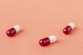 Scattering of red and white drug capsules Royalty Free Stock Photo