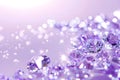 A scattering of shining diamonds on a delicate purple background with space for text Royalty Free Stock Photo