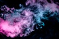 The scattering smoke on a black background smoothly flows in the neon light of pink violet