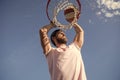 sccessful man dunking basketball ball through net ring with hands, sport hobby Royalty Free Stock Photo