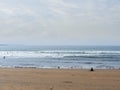 Scene at a beach, Woman wathching serfers. Silverstrand, Sligo, Ireland